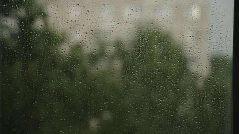Large raindrops on the window during the rain against the background of the city Stock Footage 337073245
