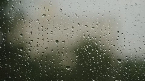Large raindrops on the window during the rain against the background of the city Stock Footage 337073301