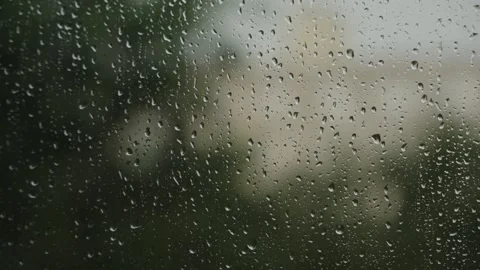 Large raindrops on the window during the rain against the background of the city Stock Footage 337073433