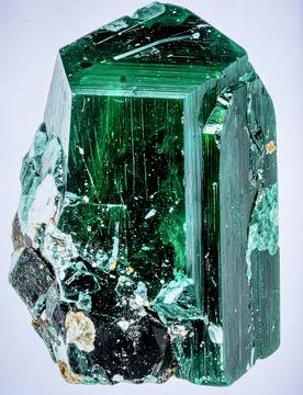A large raw emerald crystal in matrix with deep green color and natural Stock Photos