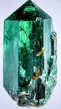 A large raw emerald crystal in matrix with deep green color and natural Stock Photos