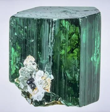 A large raw emerald crystal in matrix with deep green color and natural inc.. Stock Photos