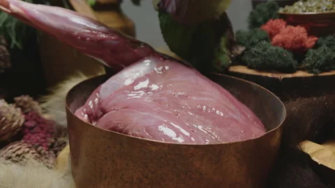 Large raw ham in copper dish on set table in restaurant kitchen Stock Footage 205329069