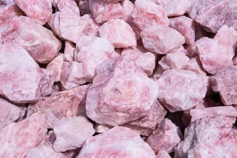 Large raw rose quartz chunks are natural pink-hued crystals often used in d.. Stock Photos