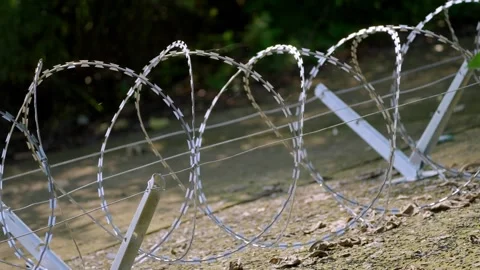 Large Razor Wire Loops on Angled Metal Supports, Side View Stock-Footage 344120633