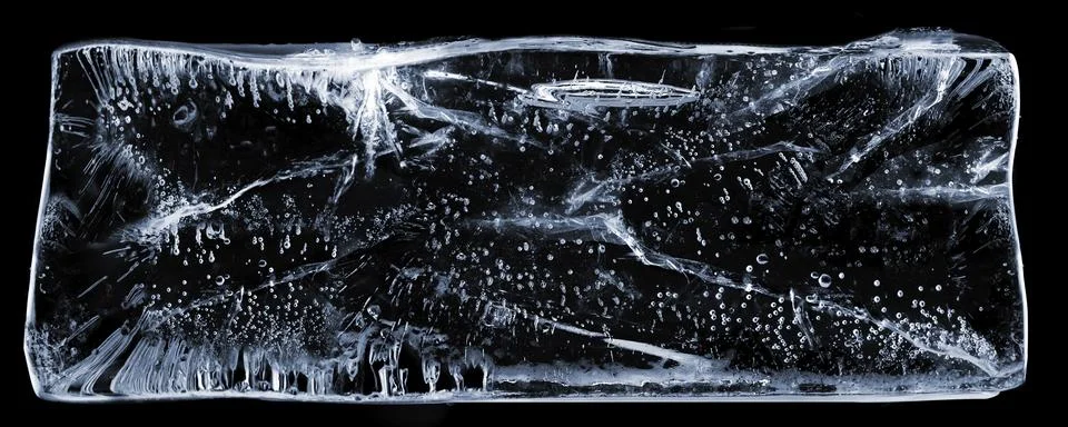 Large rectangle of clear ice with bubbles, on black Stock Photos