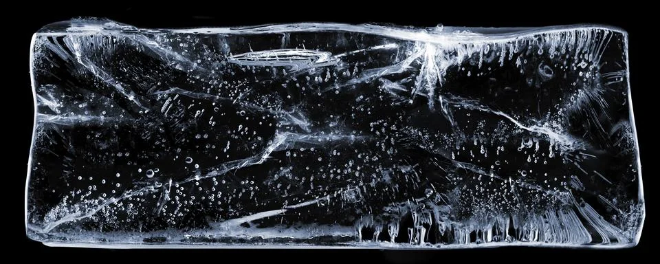 Large rectangle of clear ice with bubbles, on black Stock Photos