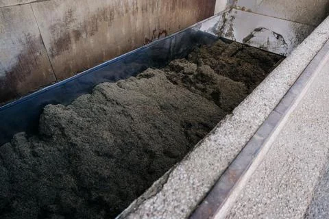 Large Rectangular Container with Dark Material in Industrial Setting Stock Photos