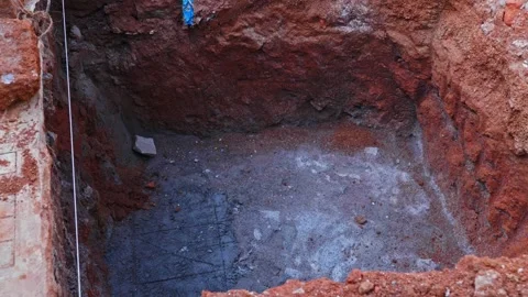 A large rectangular pit excavated and prepared for building foundation work at Stockbeeldmateriaal 320398252