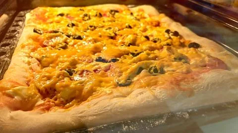 Large rectangular pizza baked in the oven. Stock-Fotos