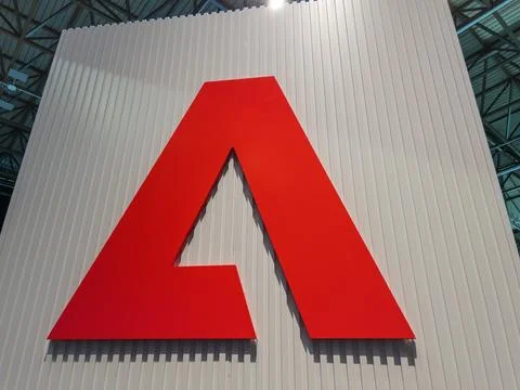 Large Red Adobe Logo Displayed at Event Stock Photos