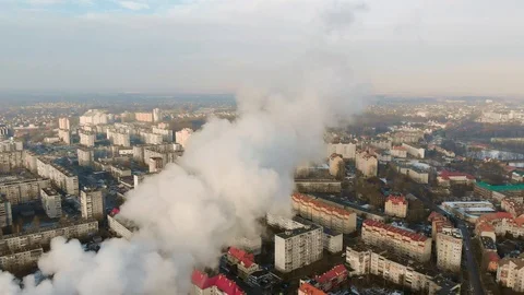 A large red and white chimney with thick white smoke pouring out of the chimney  Stock Footage 102699440