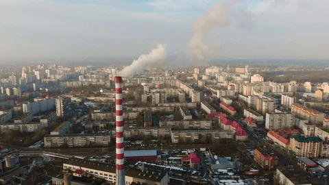 A large red and white chimney with thick white smoke pouring out of the chimney  Video stock 102699462