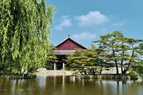 A large red building with a green tree in front of it Stock Photos