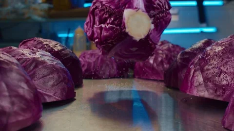 Large red cabbage falls on the table. 4K slow motion video Video stock 111629278