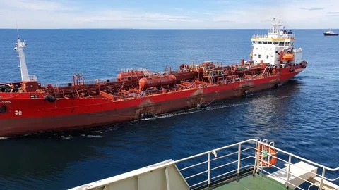 Large red cargo ship aframax drifts on blue endless sea Stock Footage 113189712