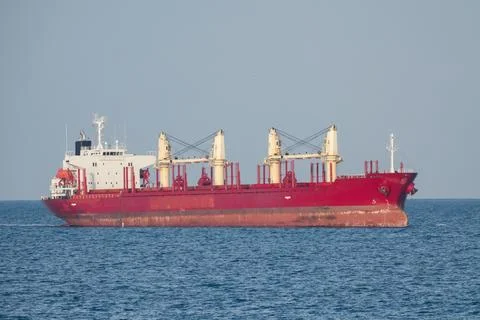 Large red cargo ship sailing in open sea Stock Photos