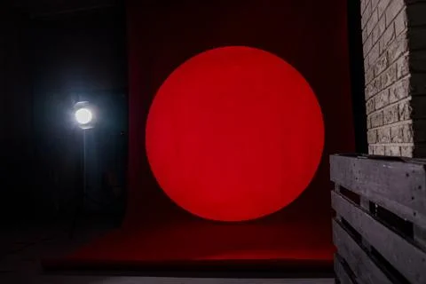 Large Red Circular Light Projection on Dark Studio Background with Professi.. Stock Photos