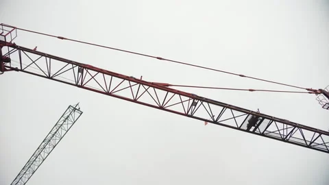 Large Red Construction Crane Against Cloudy Sky Stock Footage 303783992