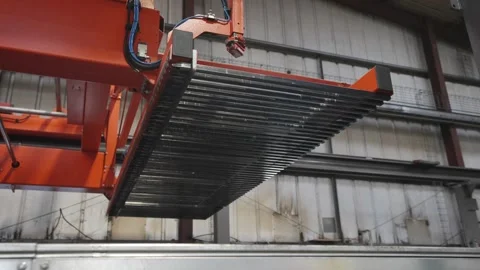 A large red crane is lifting a metal sheet Stock Footage 302458253