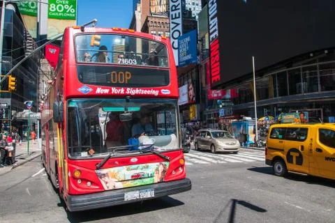 Large red double decker sightseeing tour bus full of tourists Stock Photos