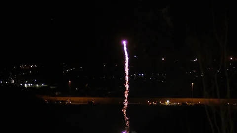 Large Red Firework Rocket Shooting up and Exploding TILT UP 動画素材 107277557