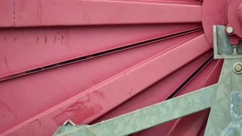 Large Red metal spool winding black hose For watering plants in the field. Ru Stock Footage 157323396
