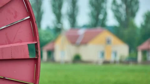 Large Red metal spool winding black hose For watering plants in the field. Ru Stock Footage 157803697