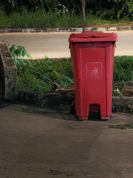 Large Red Plastic Mobile Waste Bin on Urban Roadside Stock Photos