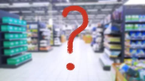 Large red question mark on abstract blur image of supermarket background. Stock Photos