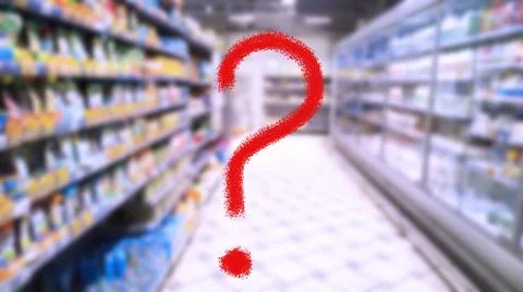 Large red question mark on abstract blur image of supermarket background. Stock Photos