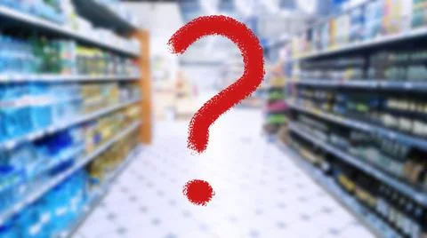 Large red question mark on blur supermarket background. Defocused shelves Stock Photos