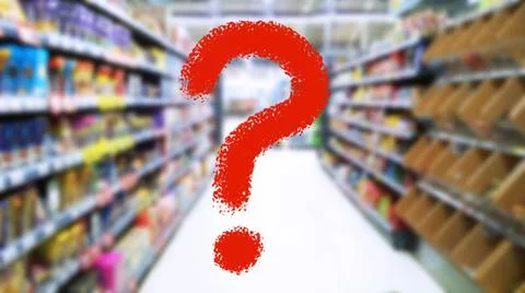 Large red question mark on blur supermarket background. Defocused shelves Stock Photos