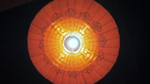 A large red round lantern with a yellow fringe swaying in the wind. Video stock 110752863
