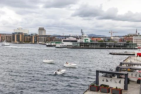 A large red ship is docked at the pier in front of a city skyline Stavanger.. Stock Photos