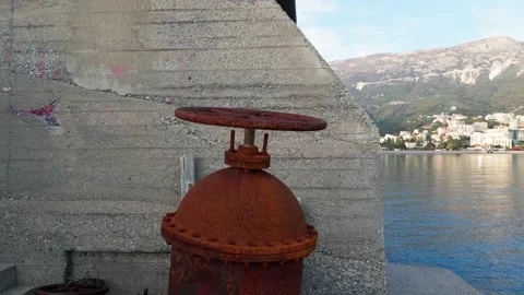 Large red valve to open and close pipes of city sewer, which is located near Stock Footage 154917799