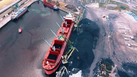 The large red vessel standing in the industrial bulk cargo terminal of the port. Stock Footage 340128588