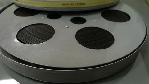 Large reel resting on a white table. Film, art, images Stock Footage 109263232