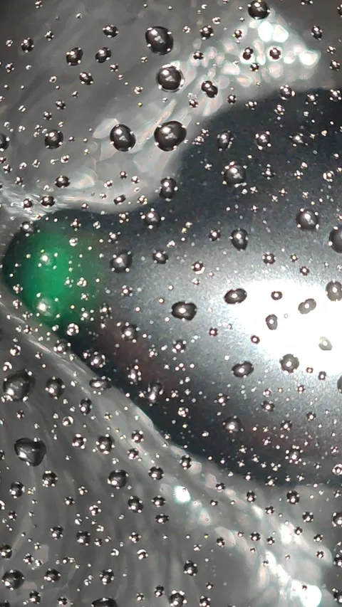 The large refraction of light is mesmerizing as the drops move in a circle. Stock Footage 325050847