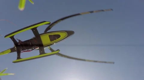 Large Remote Control Helicopter accelerating fast to altitude and doing looping Stock Footage 53176712