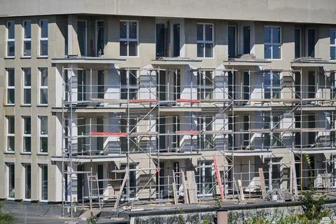 Large residential construction site featuring metal scaffolding and balcony s Stock Photos