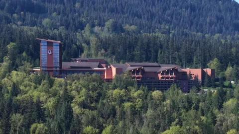 Large resort complex sits surrounded by dense pine forest near Snoqualmie Stock Footage 339090743