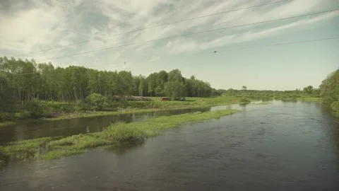A large river with an island flowing through flatlands in summer day Stock Footage 159980914