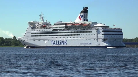Large river-sea ferry sails on river to port past green bank Stock Footage 113091455