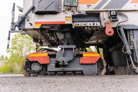 Large Road cold milling machine removes the old asphalt and loading Stock-Fotos