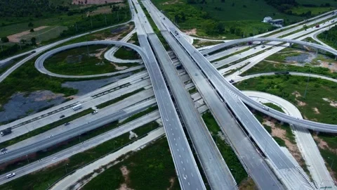 Large road interchange featuring multiple lanes, bridges, ramps, and complex eng Video stock 343904408