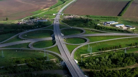 Large road Interchange on the highway bridge over the river power lines over the Vídeos de archivo 118166811