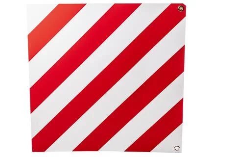 A large road sign displays a pattern of red and white stripes, warning driver Stock Photos