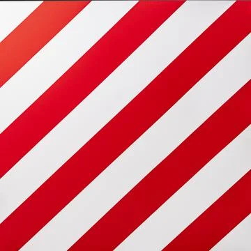 A large road sign displays a pattern of red and white stripes, warning driver Stock Photos