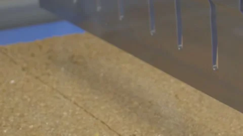 A large robotic cutter slices cake bars to size. Automated food factory Stock Footage 132166820